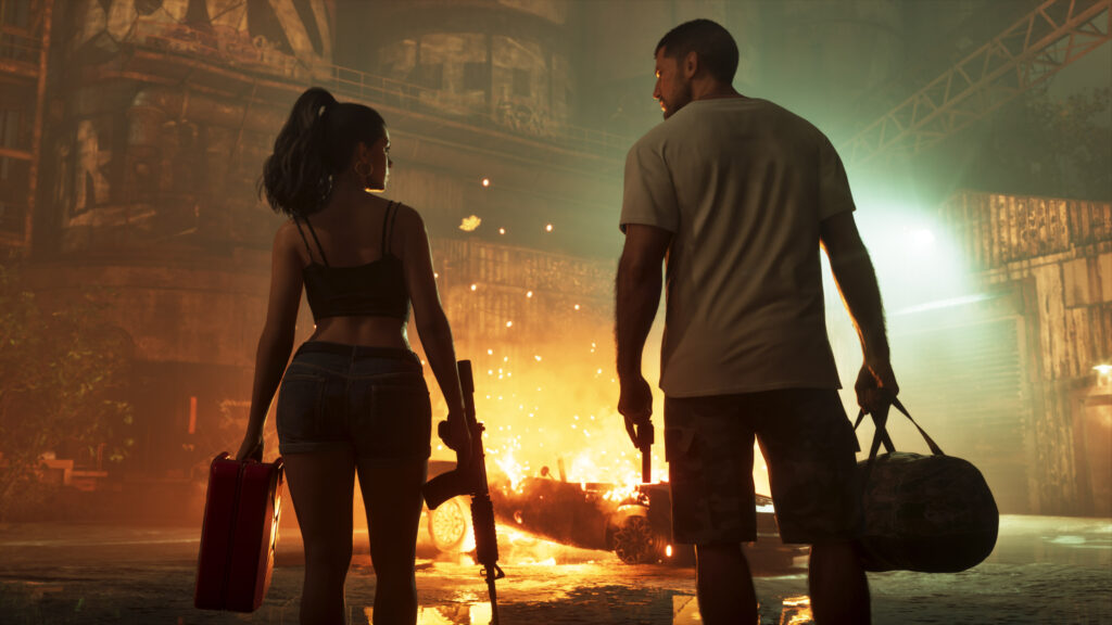Jason Duval and Lucia Caminos walking through a fire-lit industrial scene in an official Grand Theft Auto VI screenshot by Rockstar Games.